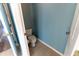 Small water closet room with commode, door and blue painted walls at 16201 Sw 47Th Ter, Ocala, FL 34473