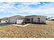 Charming single-story home featuring a clean stucco facade, attached garage, and a neatly maintained front yard at 1698 Ne 161 St, Citra, FL 32113