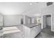 Open kitchen featuring an island with gray countertops, leading to a spacious living area with tile and carpet flooring at 1698 Ne 161 St, Citra, FL 32113