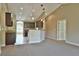 Open living space with granite countertops, pendant lighting and modern, dark cabinets at 17908 Sw 32Nd Cir, Ocala, FL 34473