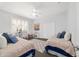 Bright bedroom with two beds, ceiling fan, a large window, desk, and closet at 1910 Se 28Th Pl, Ocala, FL 34471