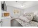 Well-lit bedroom features a decorative rug, ceiling fan, and large windows for ample natural light at 1910 Se 28Th Pl, Ocala, FL 34471