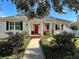 Charming single-story home boasts a beautifully landscaped front yard and inviting red door, complete with an American flag at 1910 Se 28Th Pl, Ocala, FL 34471