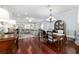 Open-concept living and dining room with hardwood floors and an elegant chandelier at 1910 Se 28Th Pl, Ocala, FL 34471
