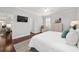Bright main bedroom featuring wood floors and an upholstered armchair at 1910 Se 28Th Pl, Ocala, FL 34471
