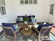 Cozy outdoor seating area with wicker furniture, colorful cushions, and a striped rug at 1910 Se 28Th Pl, Ocala, FL 34471