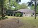 The backyard offers a screened pool area, mature landscaping, and a spacious lawn at 19903 Sw 97Th Ln, Dunnellon, FL 34432