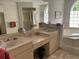 Primary bathroom featuring double sinks, soaking tub, vanity, and walk-in glass shower at 19903 Sw 97Th Ln, Dunnellon, FL 34432