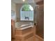 Bathroom with soaking tub by frosted glass window and separate glass shower at 19903 Sw 97Th Ln, Dunnellon, FL 34432
