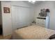 Bedroom featuring a closet, dresser, bed with patterned comforter, and a picture frame at 19903 Sw 97Th Ln, Dunnellon, FL 34432