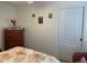 Bedroom with hardwood floors, door, window, and floral bedding at 19903 Sw 97Th Ln, Dunnellon, FL 34432