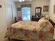 Bright bedroom with floral bedding, ceiling fan, and double door closet at 19903 Sw 97Th Ln, Dunnellon, FL 34432