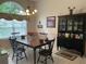 Traditional dining room with large window, chandelier, and beautiful black china cabinet at 19903 Sw 97Th Ln, Dunnellon, FL 34432