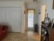 Well-lit entryway with closet, back door, and a display shelf with decorative items and pictures at 19903 Sw 97Th Ln, Dunnellon, FL 34432