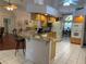 Open kitchen with granite countertops, breakfast bar, and stainless steel appliances at 19903 Sw 97Th Ln, Dunnellon, FL 34432