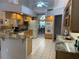 Bright kitchen featuring tile floors, granite countertops, and modern appliances at 19903 Sw 97Th Ln, Dunnellon, FL 34432