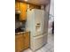 Kitchen fridge with cabinets and granite countertops at 19903 Sw 97Th Ln, Dunnellon, FL 34432