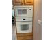 Kitchen oven and microwave with cabinets, hardware, and tile flooring at 19903 Sw 97Th Ln, Dunnellon, FL 34432