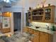 Kitchen with ample storage cabinets, under cabinet lighting, and granite countertops at 19903 Sw 97Th Ln, Dunnellon, FL 34432