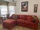 Comfortable living room with a large sofa, decorative pillows, and a bay window at 19903 Sw 97Th Ln, Dunnellon, FL 34432