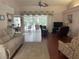 Spacious living room with hardwood floors and a view of the pool area at 19903 Sw 97Th Ln, Dunnellon, FL 34432