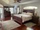Comfortable main bedroom with wood floors and tray ceiling at 19903 Sw 97Th Ln, Dunnellon, FL 34432
