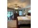Bright main bedroom with hardwood floors, pool view and sliding glass door at 19903 Sw 97Th Ln, Dunnellon, FL 34432