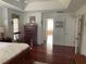 Spacious main bedroom with hardwood floors, dresser, and natural lighting at 19903 Sw 97Th Ln, Dunnellon, FL 34432