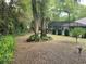 An enclosed pool area in the backyard, with mature landscaping and tall trees providing ample shade at 19903 Sw 97Th Ln, Dunnellon, FL 34432