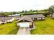 Aerial view showcasing the home's roof, two-car garage, driveway and expansive green lawn at 2146 Ne 10Th St, Ocala, FL 34470