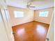 Bedroom showcasing hardwood floors, two windows, and neutral paint at 2146 Ne 10Th St, Ocala, FL 34470