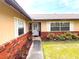 Up-close view features a front door, brick accents, surrounding plants and shutters on a home at 2146 Ne 10Th St, Ocala, FL 34470