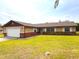 Single-story home features a two-car garage, a combination of beige siding, brick accents and a well-kept lawn at 2146 Ne 10Th St, Ocala, FL 34470