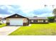 Charming single-story home features a two-car garage, brick accents and a well-manicured lawn at 2146 Ne 10Th St, Ocala, FL 34470