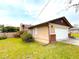 Tan home with a brick trimmed garage, nice lawn, and landscaping at 2146 Ne 10Th St, Ocala, FL 34470