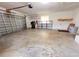 Attached garage with garage door, shelving, and laundry hamper at 2146 Ne 10Th St, Ocala, FL 34470