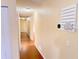 Hallway with wood floors featuring a thermostat and decor on the wall at 2146 Ne 10Th St, Ocala, FL 34470