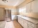 Updated kitchen with white cabinetry, stainless steel appliances, and tile flooring at 2146 Ne 10Th St, Ocala, FL 34470