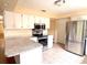 Kitchen featuring a breakfast bar, stainless steel appliances, and granite counters at 2146 Ne 10Th St, Ocala, FL 34470