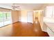 Bright living room featuring hardwood floors, sliding doors, and a ceiling fan at 2146 Ne 10Th St, Ocala, FL 34470