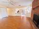 Open floor plan with hardwood floors, fireplace, and a view of the kitchen at 2146 Ne 10Th St, Ocala, FL 34470