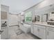 Bright bathroom featuring double vanity, freestanding tub, and walk-in shower at 3920 Se 7Th Ave, Ocala, FL 34480