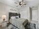 Bedroom with ceiling fan, wood-paneled headboard, and accent rug at 3920 Se 7Th Ave, Ocala, FL 34480