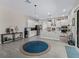 Open-concept kitchen boasts white cabinetry, stainless steel appliances, a center island, and sleek pendant lighting at 3920 Se 7Th Ave, Ocala, FL 34480