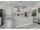 Bright kitchen featuring white cabinets, an island, and modern appliances against a backdrop of neutral paint at 3920 Se 7Th Ave, Ocala, FL 34480