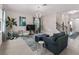 Cozy living room featuring plush seating, a modern light fixture, and serene views from large windows at 3920 Se 7Th Ave, Ocala, FL 34480
