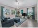 Inviting living room with ample seating, a large TV, and sun-drenched windows with stylish drapes at 3920 Se 7Th Ave, Ocala, FL 34480