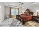 Luxurious main bedroom featuring a tray ceiling, elegant furnishings, and natural light at 3920 Se 7Th Ave, Ocala, FL 34480