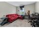 Home office area with an L-shaped couch, a window, and a desk at 3920 Se 7Th Ave, Ocala, FL 34480
