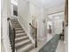 Carpeted staircase with wood banister, leading to the upper level of the home at 3920 Se 7Th Ave, Ocala, FL 34480